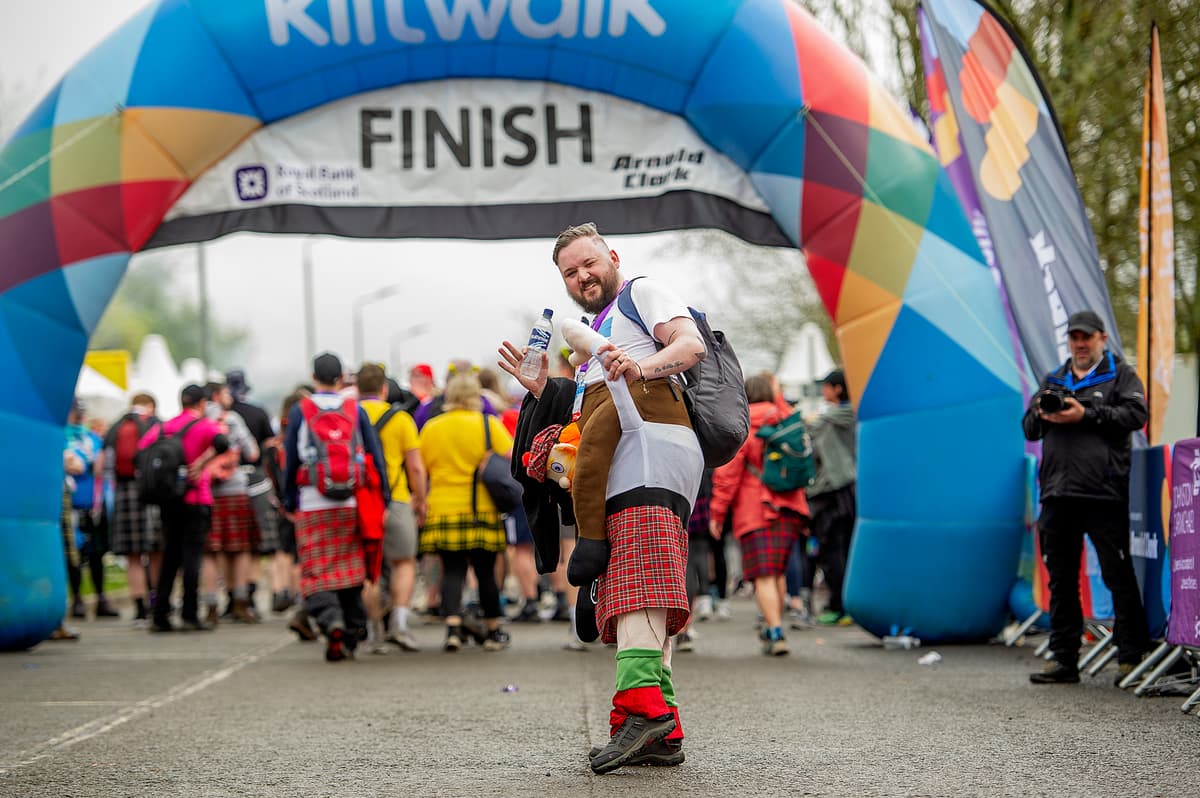 Man at Kiltwalk finish line.