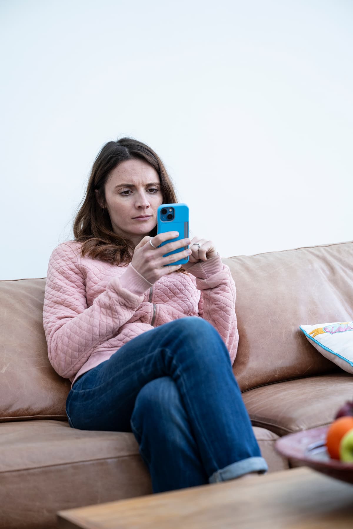 The image is of a woman typing on her phone.