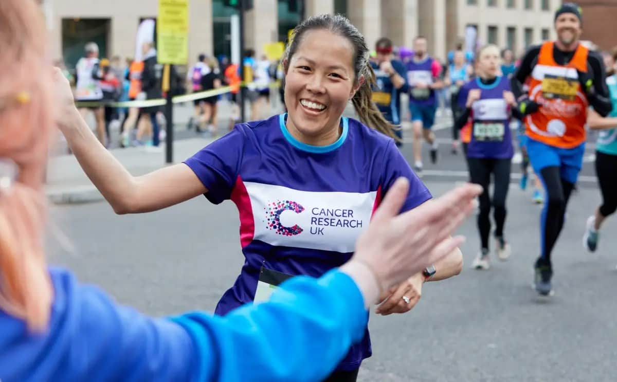 Lady running ready to high five.