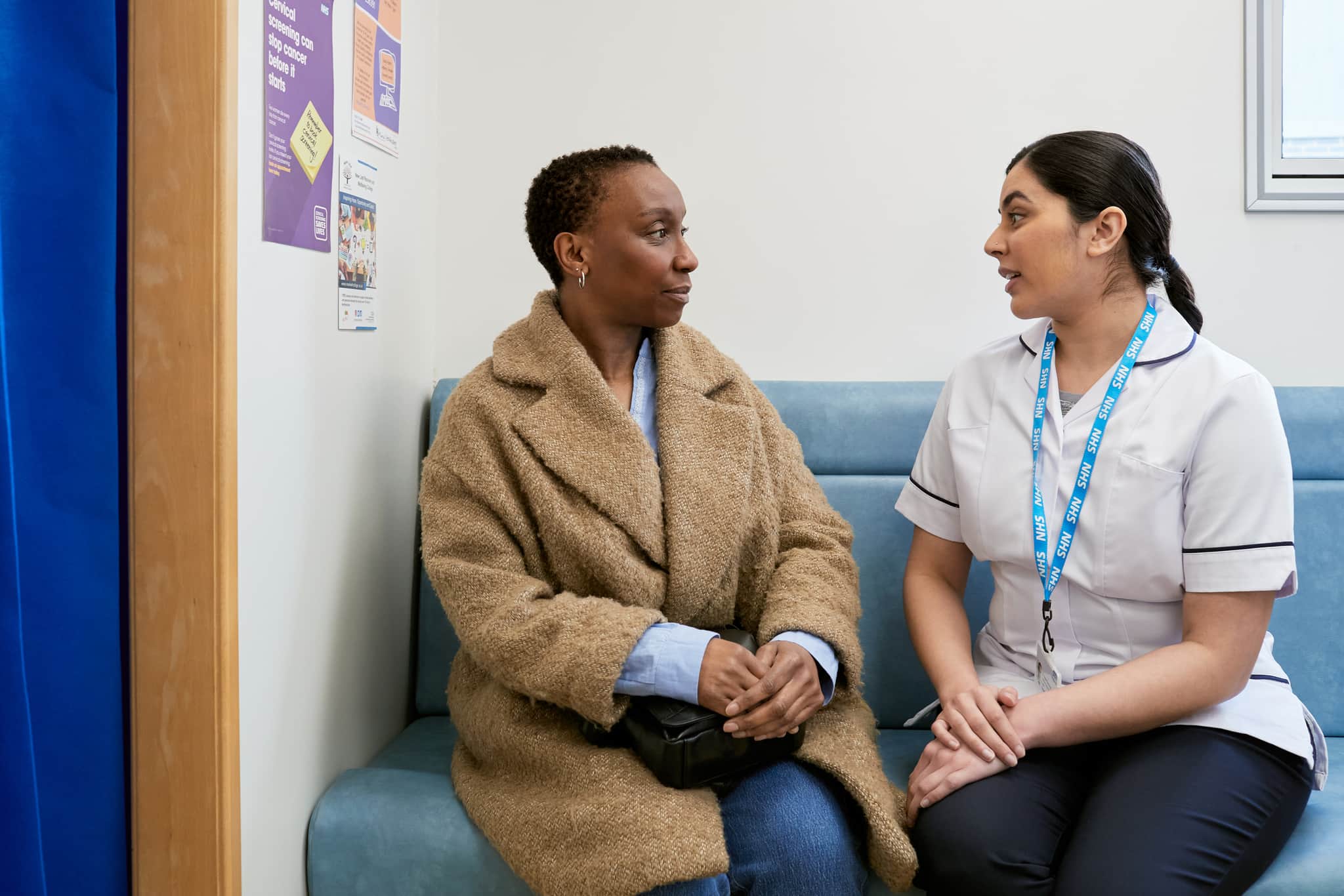 This photo shows a patient and mamographer in the waiting room of a mobile breast screening unit.