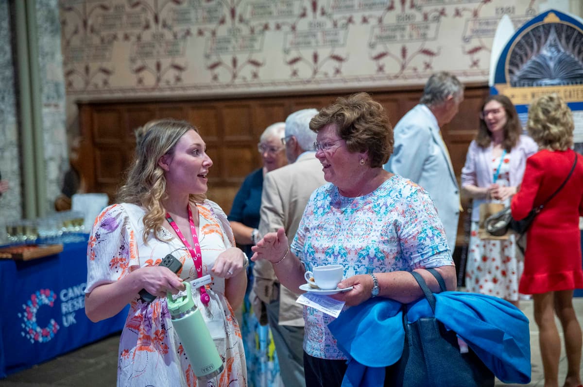 A Legacy Focused Relationship Manager speaking to a supporter at our Evening of Summer Music Event.