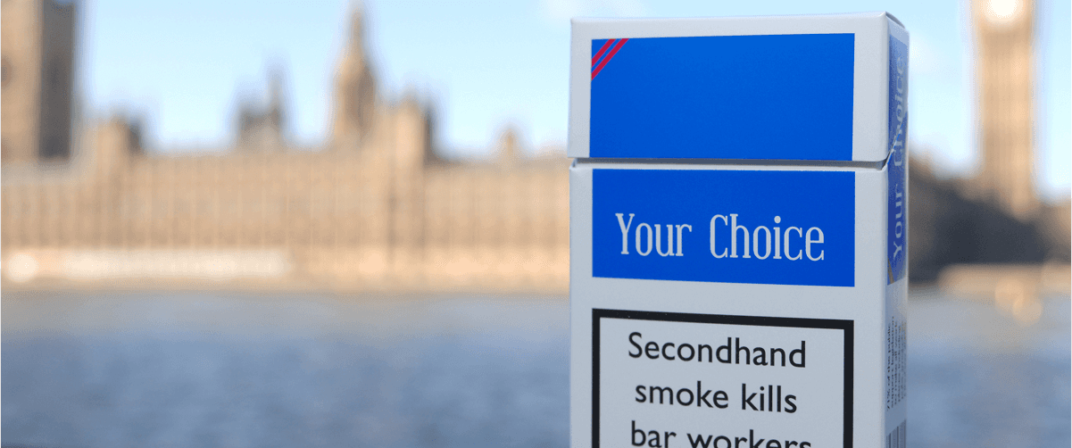 A photo of a cigarette pack in front of the House of Parliament.