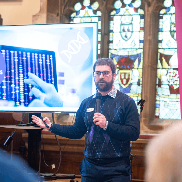 Speaker talking to supporters at a Legacy Inspire event.