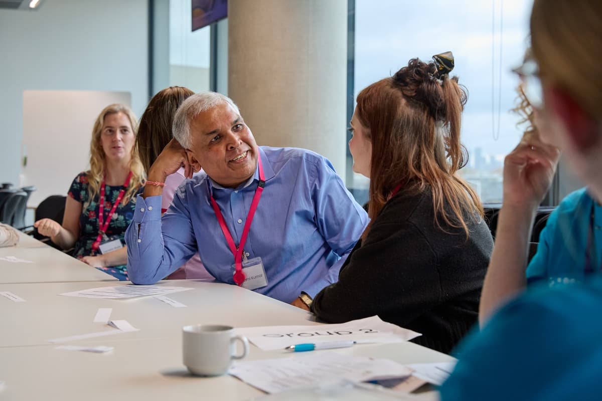 A photo of two patient involvement network members talking.