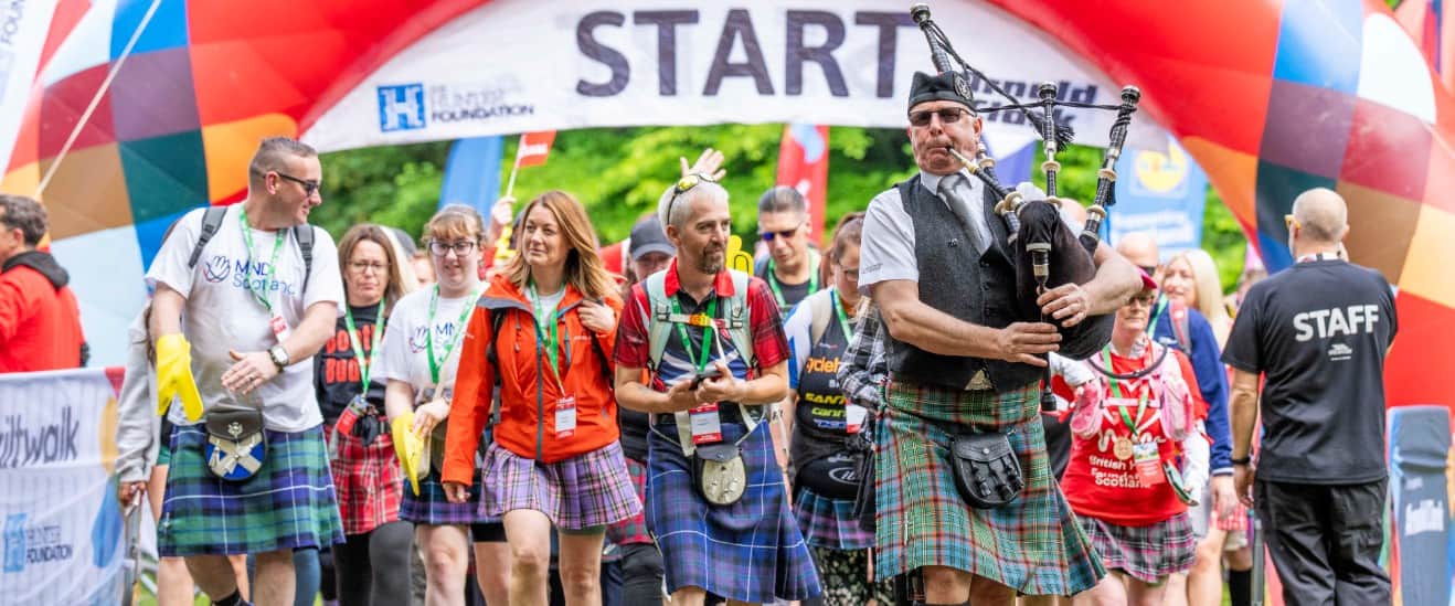 Participants wearing kilts and playing bagpipes.