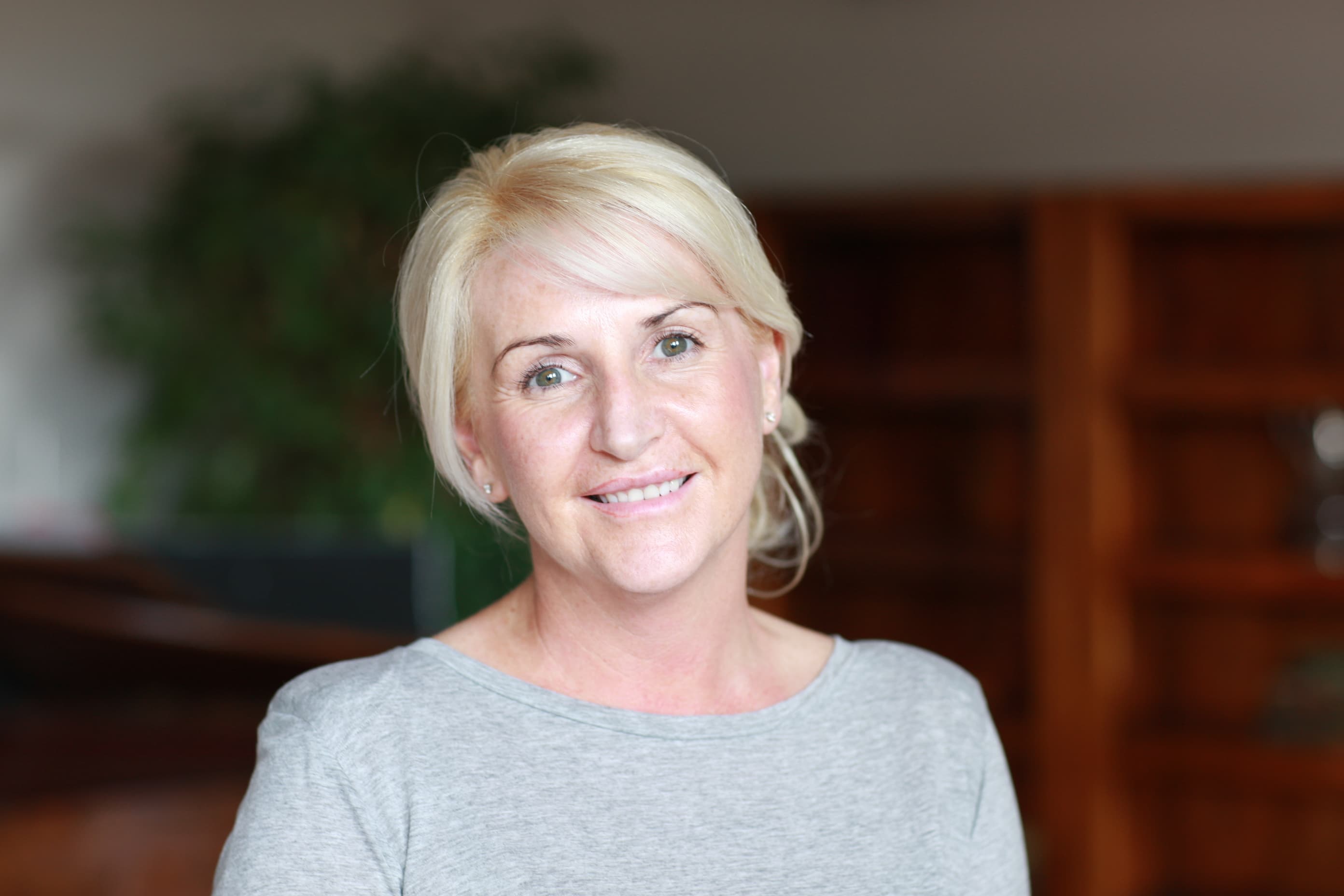 Image of Justine, smiling and looking at the camera.