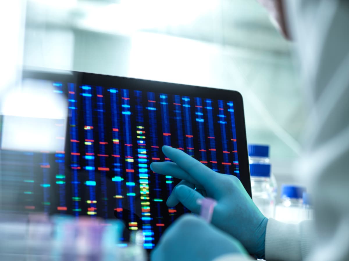 Scientist examining DNA results (genome) on a screen during an experiment in the laboratory.