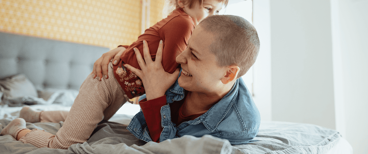 A photo of a mother with her child laughing.