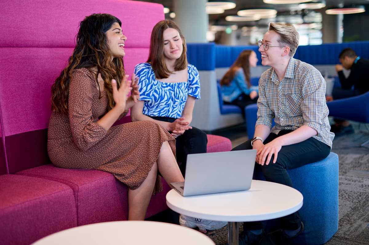 A photo of three Cancer Research UK's employees talking.