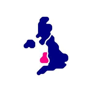 A navy blue icon of the UK with Wales in magenta.