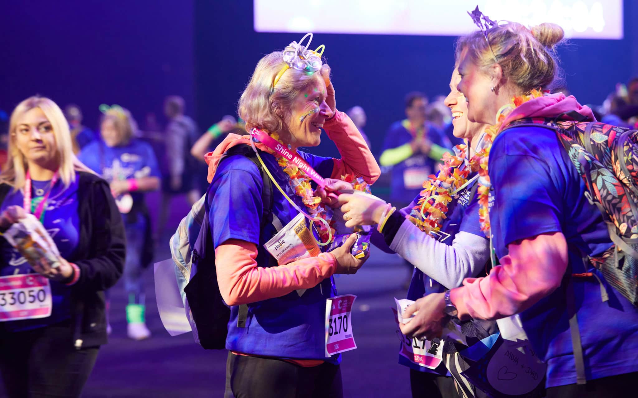 Three women wearing Shine t-shirts standing together and smiling.