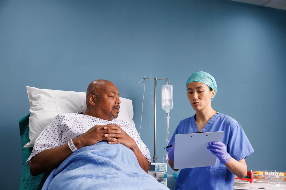 Image of a researcher or doctor speaking to a patient.
