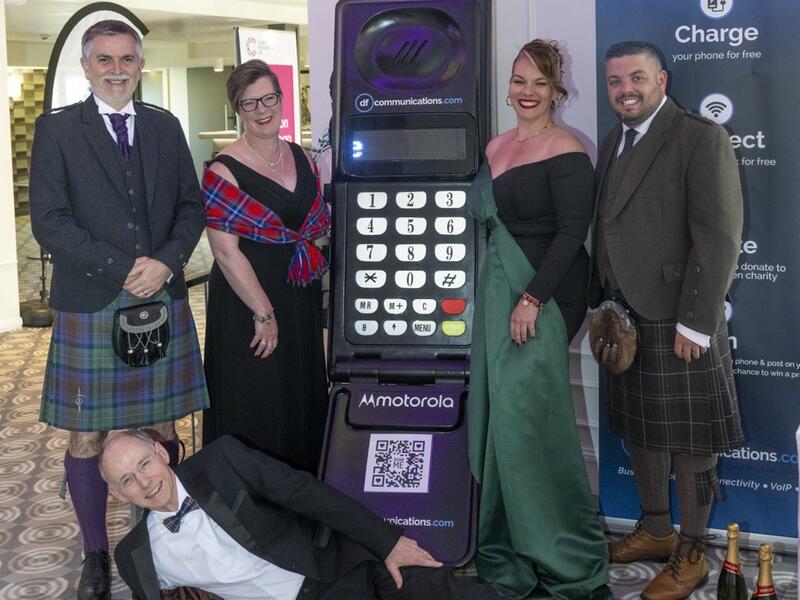 Business Beats Cancer Aberdeen board posing for picture with a Motorola stand
