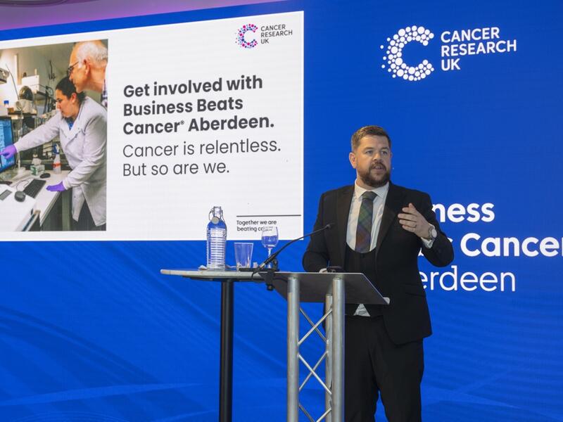 Presenter speaking at Business Beats Cancer Aberdeen event