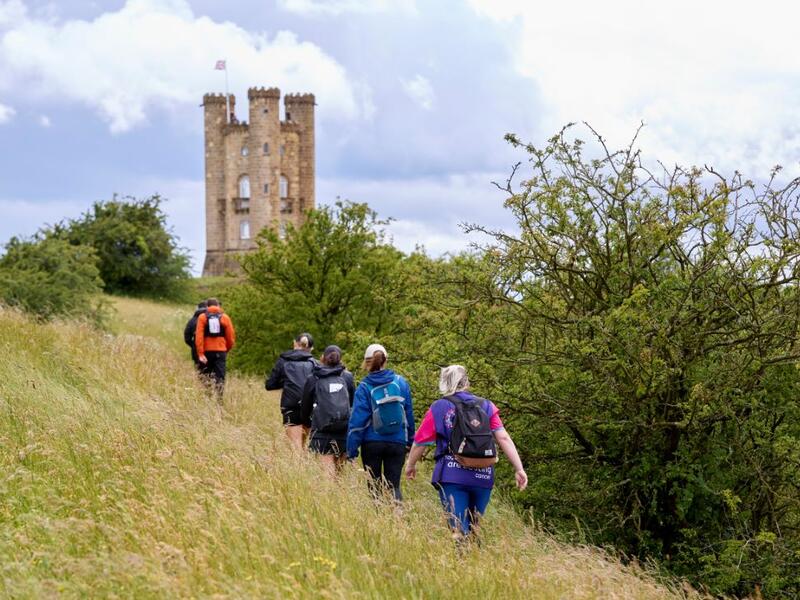 hikers heading towards Broadway tower in the Cotswolds
