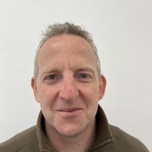 Curtis Jones, Treasurer, wearing a brown quarter zip jumper