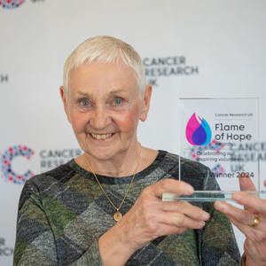Eveline holding her Flame of Hope trophy