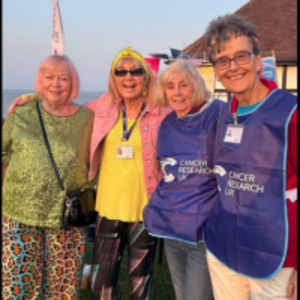 Herne Bay & Whitstable Committee standing smiling with their arms round each other