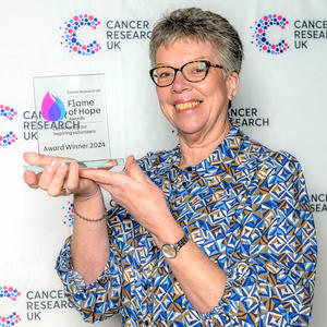 Lesley holding her Flame of Hope trophy