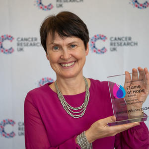 Wendy holding her Flame of Hope trophy