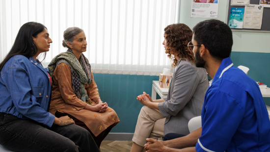 Doctors speaking to the patient and her carer. Doctors speaking to the patient and her carer.
