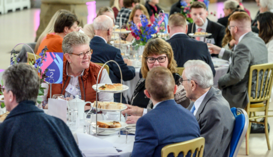 Group of people smiling round a table