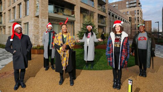 The Get Gospel choir singing outside with festive hats