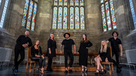 The GeO Gospel Choir on stage in a church