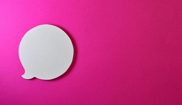 a white speech bubble on a pink background