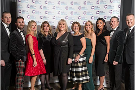 image of a group of board members, dressed up and smiling