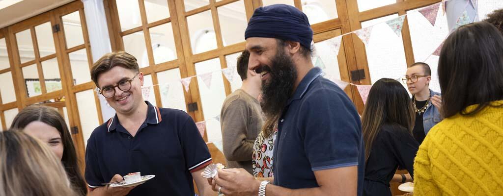 group of people enjoying a bake sale and talking