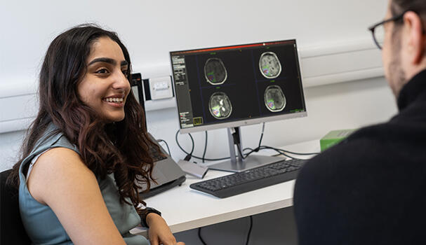 Researchers discussing brain images at a desk