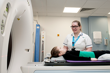 A photo of a child getting examined by a nurse