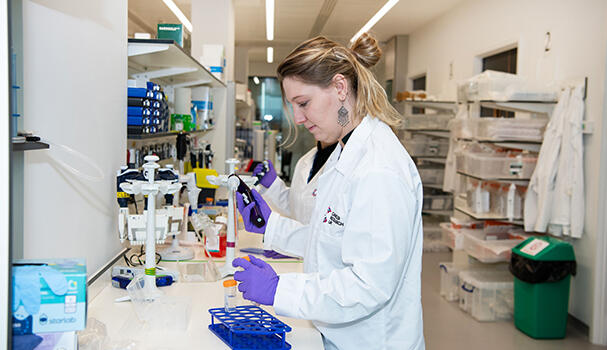 Researcher pipetting in lab