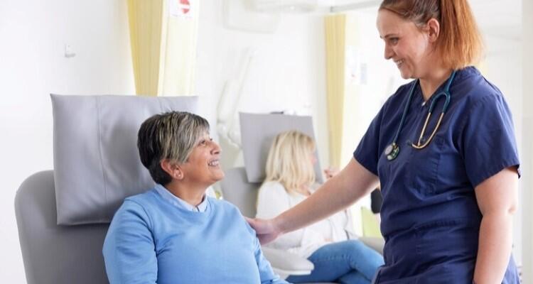 An image of a patient and a healthcare professional in a treatment room.