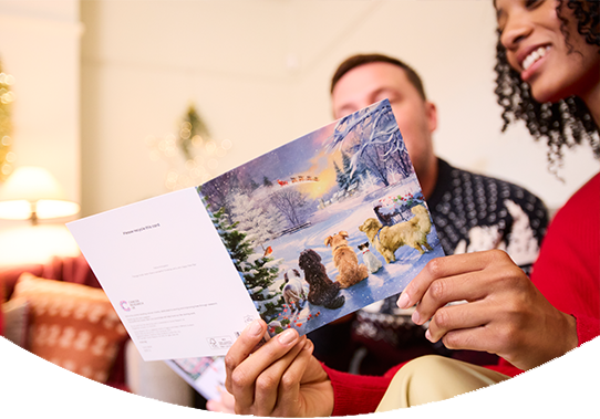 man reading christmas card