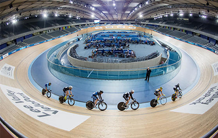 a group of cyclists cycling around the London velodrome