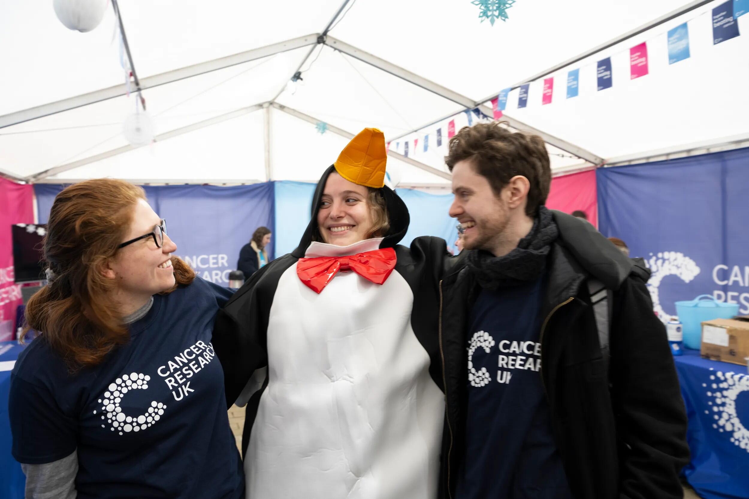 Three volunteers smiling at each other