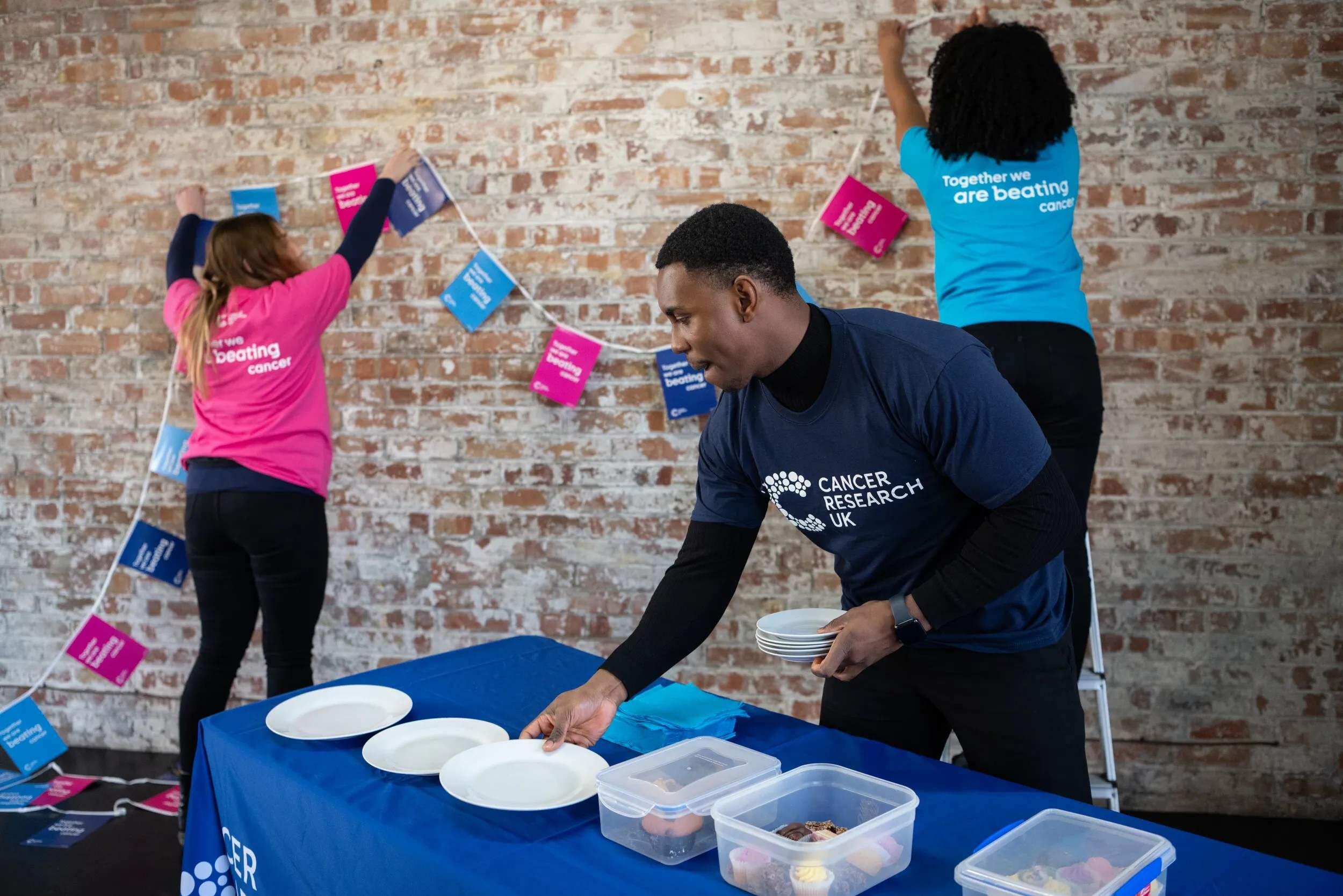Group of volunteers setting up for a bake sale activity