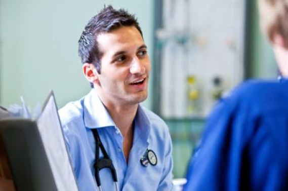 A photo of a doctor speaking to a nurse