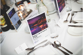 image of table place setting at an event with a program