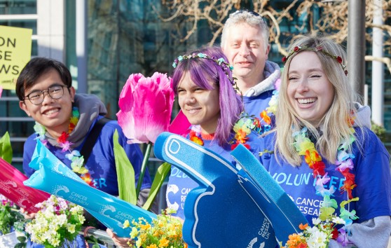 Cancer Research UK volunteers cheering at an event