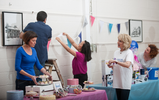 A group of volunteers setting up for a bake sale