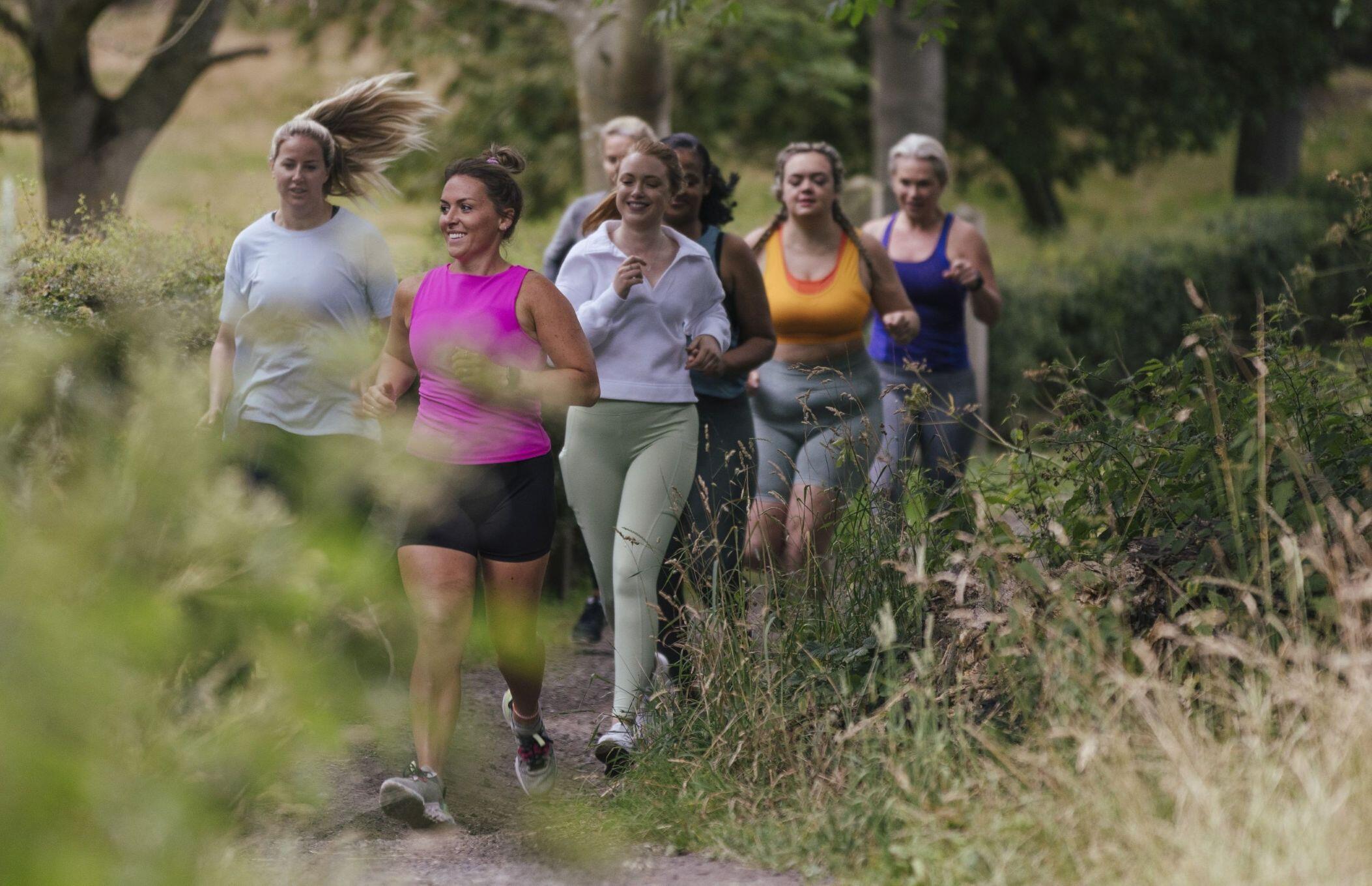 A picture of a group of women running down a path.