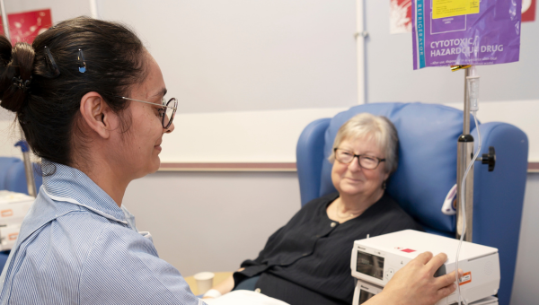 Nurse providing chemotherapy treatment to patient