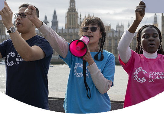 three protestors standing by the thames