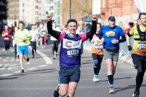 Man cheering as he runs the half marathon