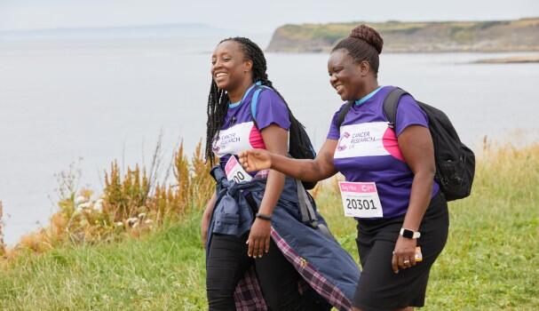 two Big Hike ladies walking and smiling along the Jurassic Coast 