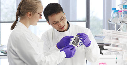 Two scientists in a lab looking at a sample