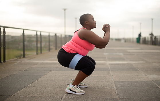 Lady squatting in urban setting